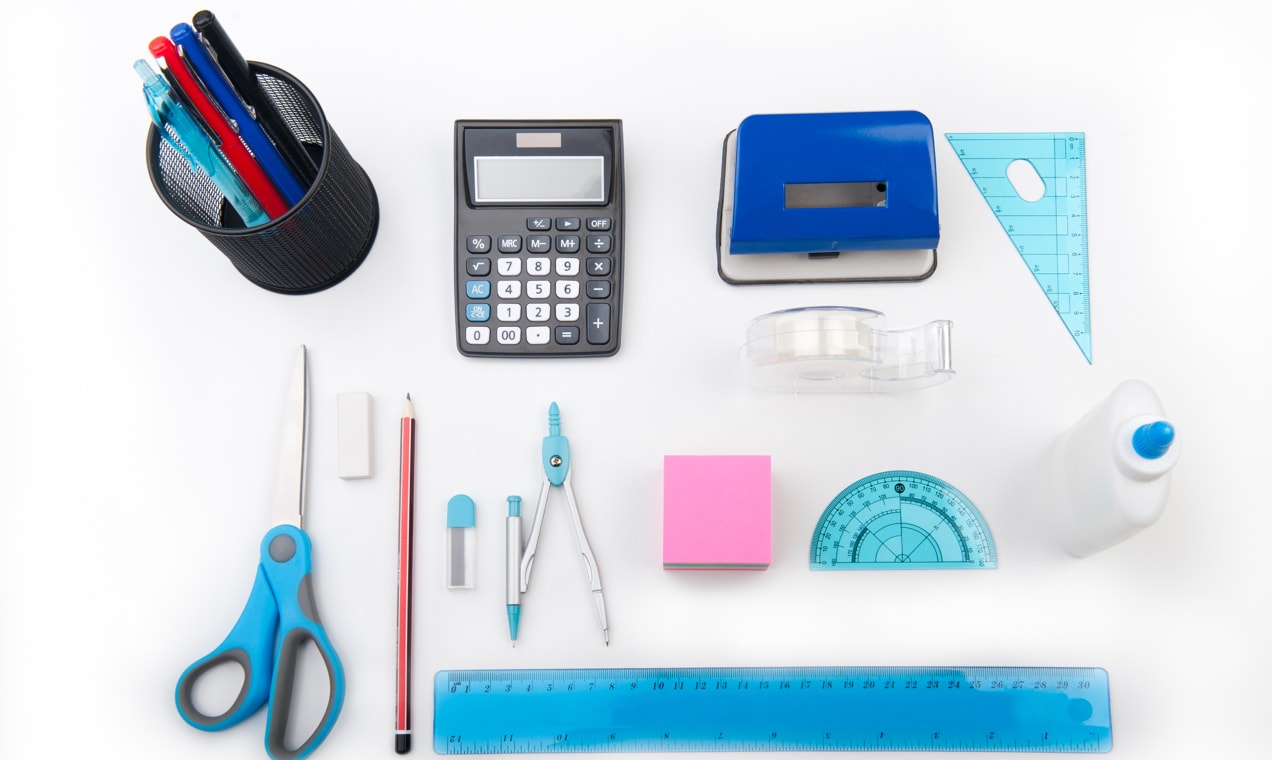 Office products on a table - pens, ruler, sticky notes, and more.