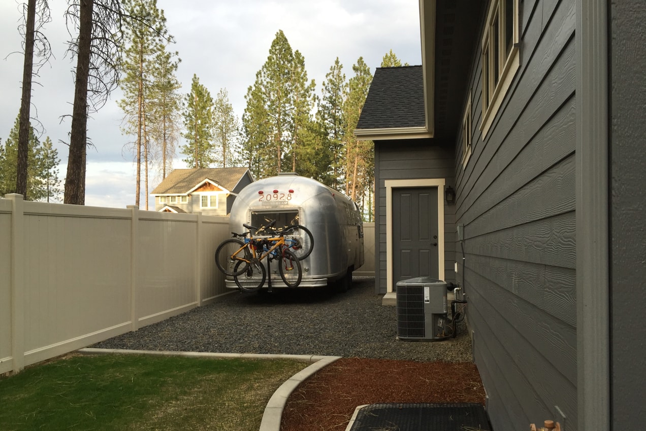Airstream trailer parked next to a friends' house