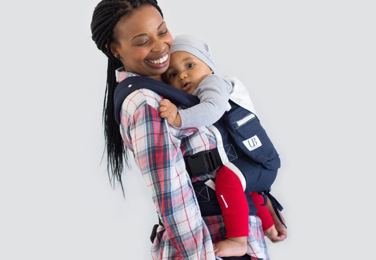 woman carrying her baby in a carrier